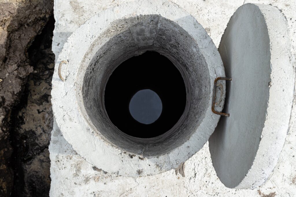 Concrete septic tank with a capacity of 10 cubic meters placed in the garden by the house.